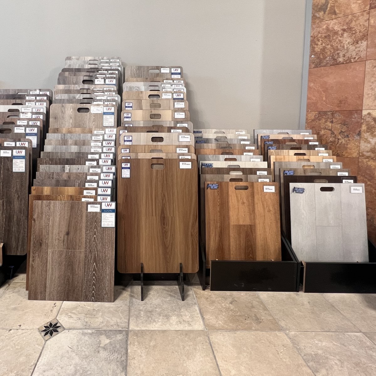 light-and-warm-vinyl-plank-flooring-evansville-in Light, gray, and warm brown luxury vinyl plank samples in the Evansville IN showroom