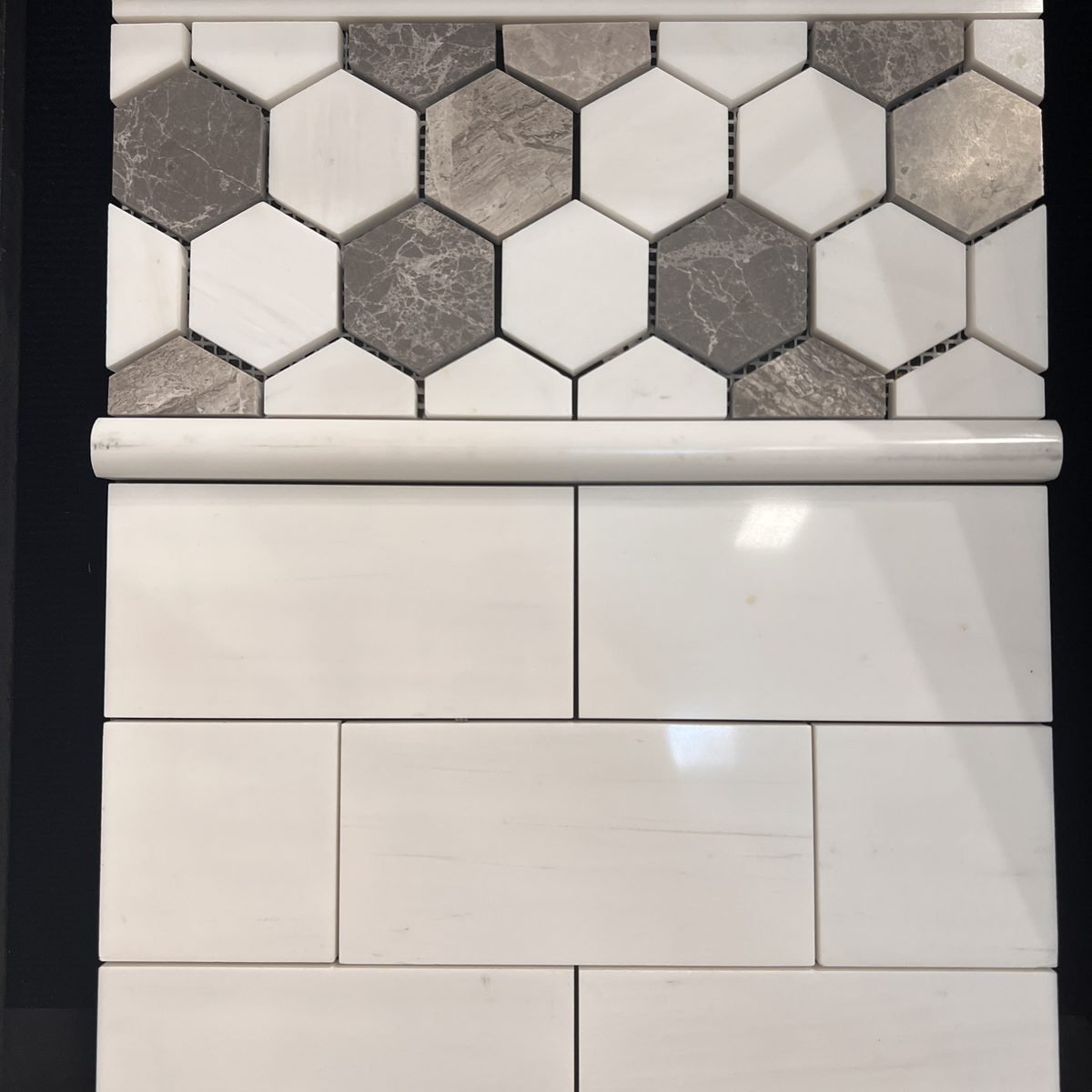 Gray and white marble hexagon mosaic with marble subway tile in Evansville IN