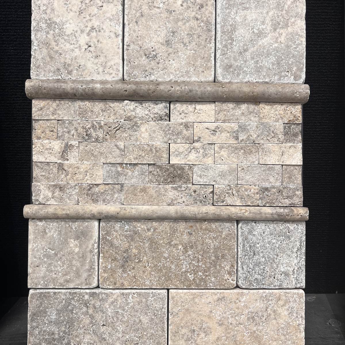 Tumbled silver travertine tile with a split face border in Evansville IN